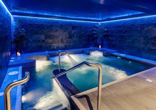 a jacuzzi tub in a room with blue lighting at Kilkea Castle in Kilkea