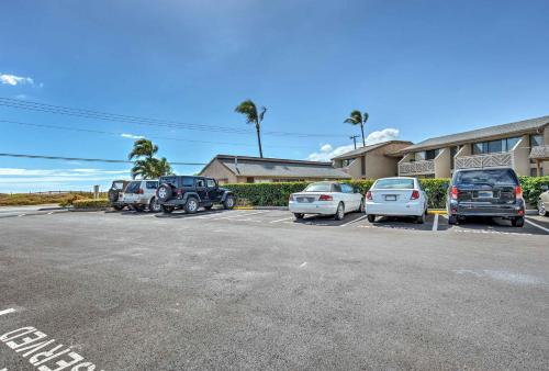 a parking lot with cars parked in front of a building at Ocean-View Kihei Condo with Pool Access! in Kihei