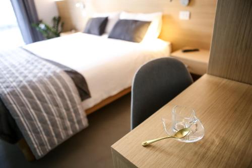 a hotel room with a bed and a table with a wine glass at Bed and Bike Verona in Verona