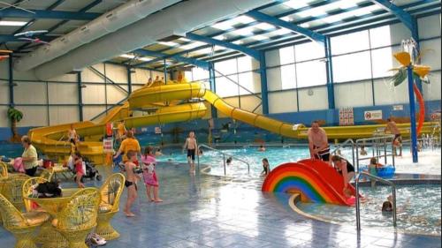 a group of people playing in a water park at Chapel Caravans PS12A in Chapel Saint Leonards