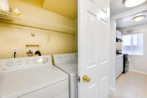 a laundry room with a white washer and dryer at Orchard Bungalow in Tucson