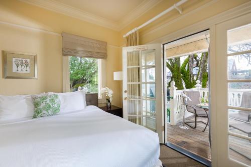 a bedroom with a bed and a balcony at Healdsburg Inn on the Plaza, A Four Sisters Inn in Healdsburg
