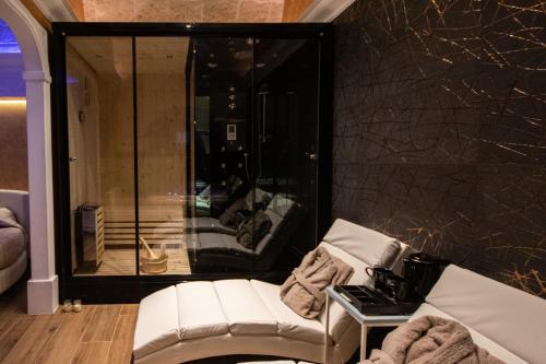 um quarto com um sofá branco e uma parede preta em Wellness Home Crisalide SPA em Fasano