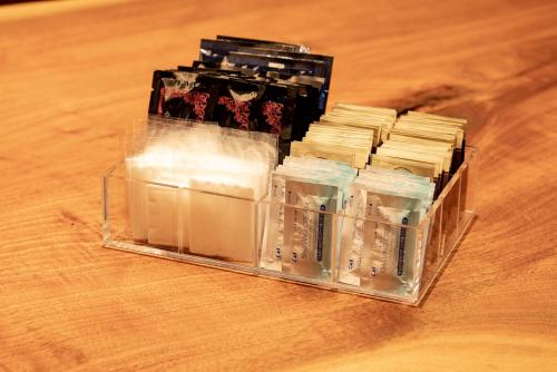 a plastic container filled with medicines on a wooden table at HOTEL FORZA HAKATAEKI CHIKUSHIGUCHI Ⅱ in Fukuoka