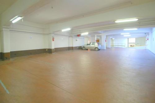an empty garage with a car parked in it at Hotel Palace Bologna Centro in Bologna