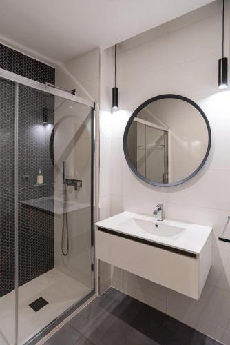 a bathroom with a sink and a shower and a mirror at Matosinhos Relax and Fun by PortoProperties4You in Matosinhos