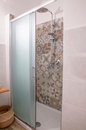 a shower with a glass door in a bathroom at AllYouCanTrip - La Nova in Naples
