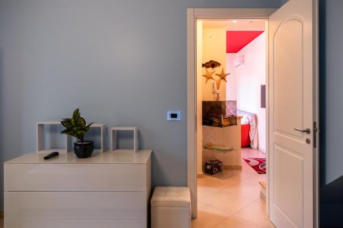 a room with a white dresser and a bedroom at casa di alessio a 200 metri dal mare in Acireale