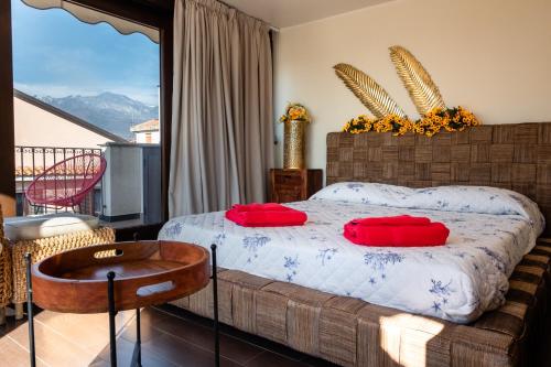 a bedroom with a bed with red pillows on it at casa di alessio a 200 metri dal mare in Acireale