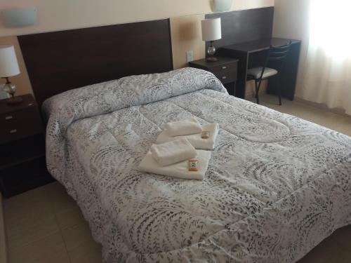 Ένα ή περισσότερα κρεβάτια σε δωμάτιο στο hotel andino