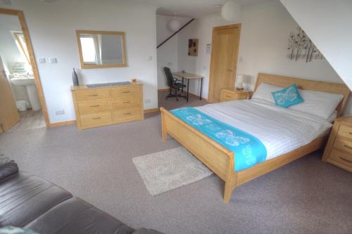a bedroom with a large bed and a desk at ArdFyne on Lochfyne in Strachur