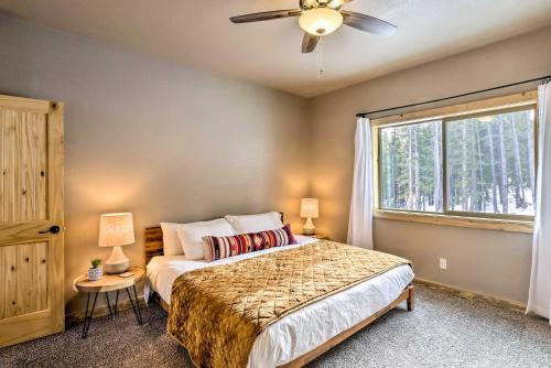 a bedroom with a bed with a ceiling fan and a window at Mountainside Fairplay Cabin with Game Room and Sauna! in Fairplay