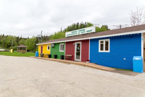 a colorful building with a sign on top of it at Middle Brook Cottages & Chalets in Glenburnie