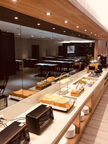 a kitchen with a long counter with food on it at Palmer Hotel in Taichung
