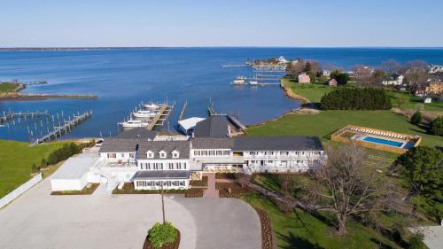 an aerial view of a large house on the water at Wylder Hotel - Tilghman Island in Saint Michaels