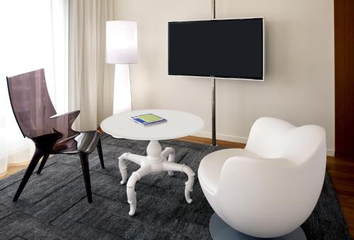 a hotel room with a table and two chairs and a tv at Mondrian Los Angeles in Los Angeles