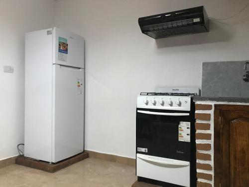 a kitchen with a refrigerator and a stove at El Valle in Tilcara