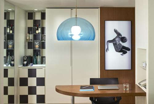 a dining room with a table and a picture on the wall at Mondrian Los Angeles in Los Angeles