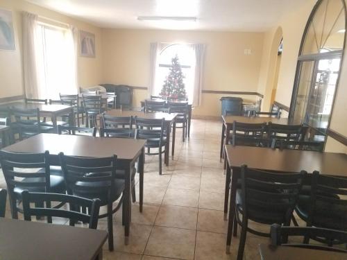 a dining room with tables and chairs and a christmas tree at Travelodge by Wyndham Kanab in Kanab