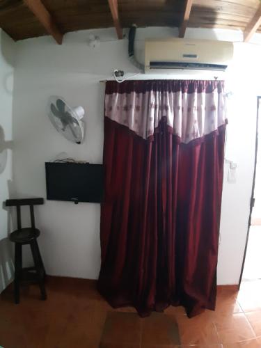 a red curtain in a room with a table at HOTEL CASA COLONIAL in San Antonio del Táchira