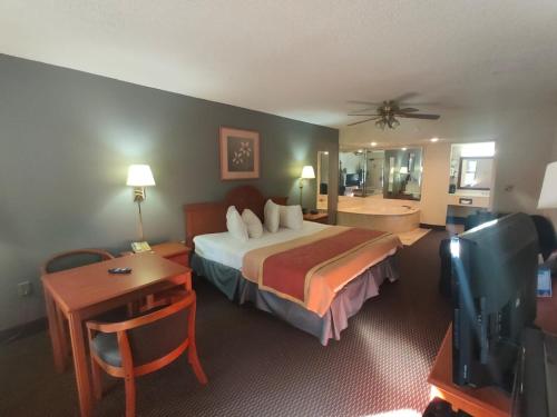 a hotel room with a bed and a bathroom at Travelodge by Wyndham Alachua in Alachua