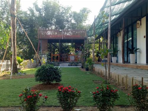 a garden in front of a building with a gazebo at Bebe Homestay Phu Quoc in Phu Quoc
