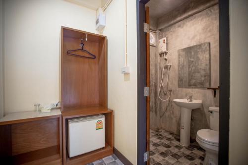 a bathroom with a toilet and a sink at Tuscany Land Resort Donmuang in Bangkok