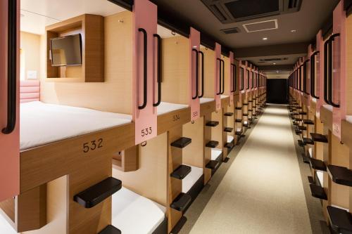 a row of lockers in a prison cell at Y's CABIN Osaka Namba in Osaka