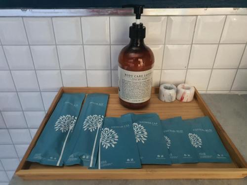 a wooden tray with books and a bottle of alcohol at Wayla Villa@Maikhaobeach in Mai Khao Beach