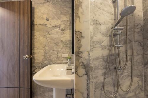 a bathroom with a sink and a shower at NaiHarn Sea Condo by Holy Cow, 1-BR, mountain view in Nai Harn Beach