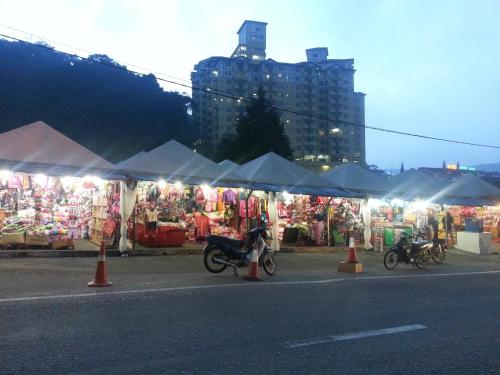 a group of motorcycles parked in front of a market at Crown imperial in Brinchang