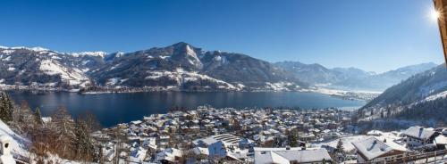 an aerial view of a town with snow covered mountains at Chalet Der Bichlhof in Zell am See