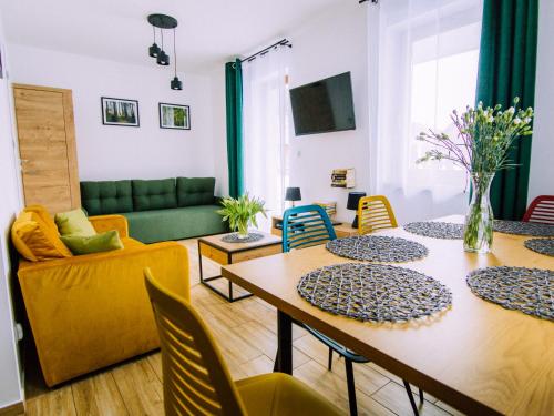 a living room with a table and chairs and a couch at Goorskie - domki w Szczyrku in Szczyrk