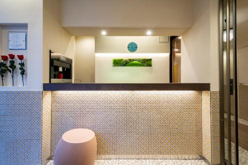 a bathroom with a tiled floor and a toilet at Hotel SAILS Asakusa in Tokyo
