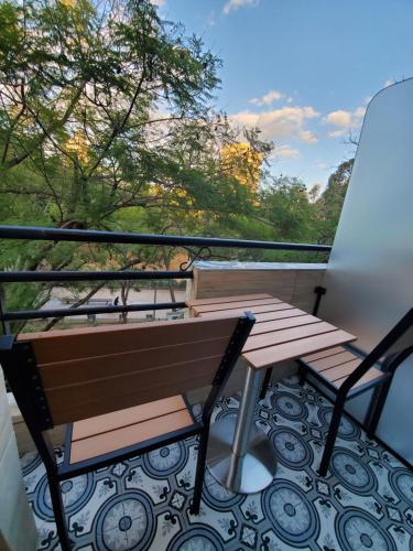 a balcony with a bench and a table at King's Rooftop Studios in Tel Aviv