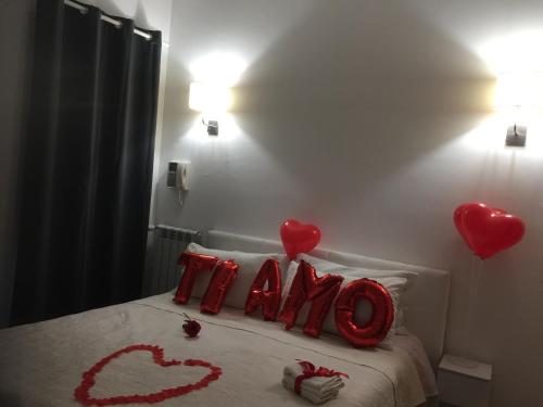 a bed with hearts spelled out on it in a bedroom at Palese Profumo di Mare in Santo Spirito