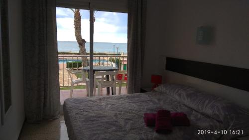 מיטה או מיטות בחדר ב-Apartamento primera línea de mar