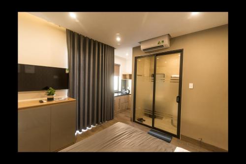 a bathroom with a shower and a sink at AHA Thang Bom Apartment Da Nang in Danang