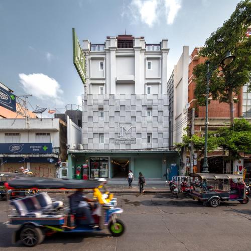 a person riding a motor bike on a city street at The Mulberry Bangkok Khaosan Road in Bangkok