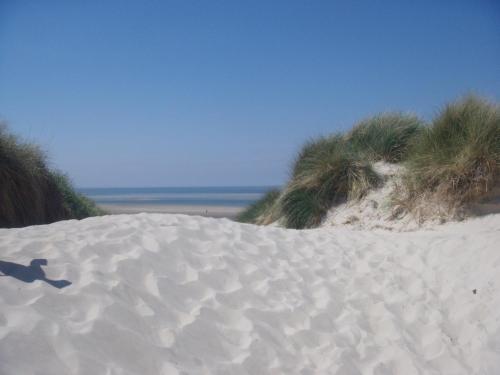 a pile of sand on top of a beach at Haus Strandburg Amrum in Wittdün