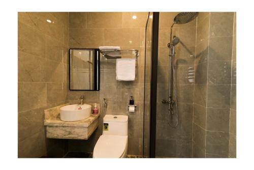 a bathroom with a toilet and a sink and a shower at AHA Thang Bom Apartment Da Nang in Danang