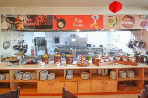 a kitchen with a counter with dishes on it at HARRIS Hotel Pontianak in Pontianak