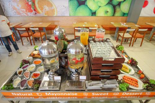 a buffet of food on a table in a restaurant at HARRIS Hotel Pontianak in Pontianak