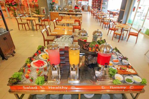 a table full of food and drinks in a restaurant at HARRIS Hotel Pontianak in Pontianak
