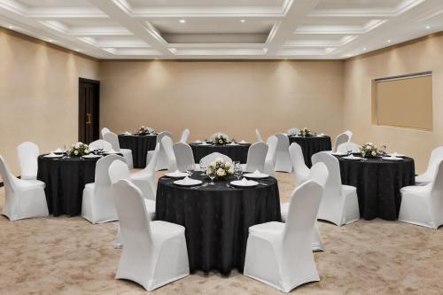 a large room with tables and chairs and a large table with chairs at Ramada by Wyndham Dubai Deira in Dubai
