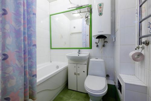 a bathroom with a sink and a toilet and a bath tub at OK! Алексея Беленца 11/1 in Tomsk