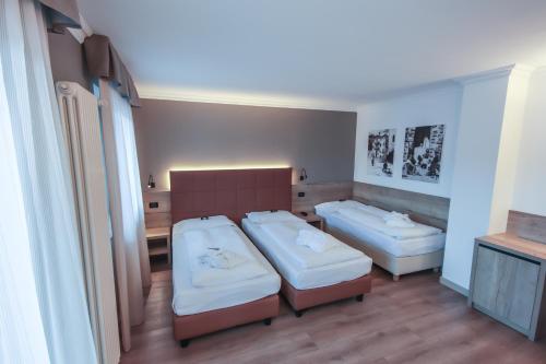 Letto o letti in una camera di Family Hotel Gran Baita
