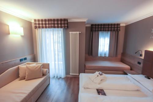 Letto o letti in una camera di Family Hotel Gran Baita
