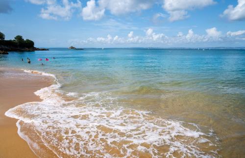 a group of people in the water at the beach at Hôtel la Baie Valdys Resort & SPA in Douarnenez