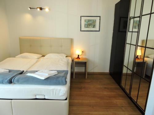 a bedroom with a white bed and a mirror at 213 Prag, Studio Apartment, 27m2, 1-2 Personen in Klagenfurt